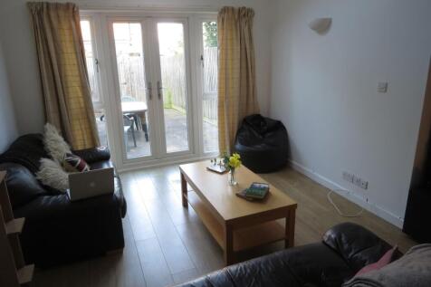 Bright and welcoming living room with large gla...