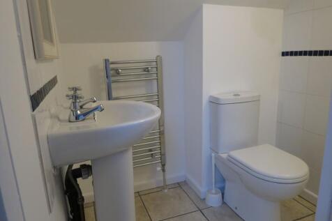 A clean, modern bathroom featuring a white toil...