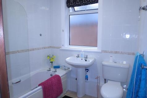 Bright and functional bathroom featuring a bath...