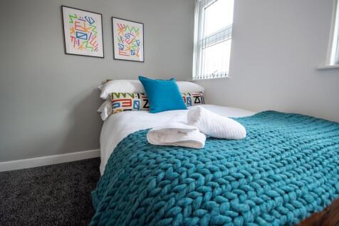 A bright and modern double bedroom featuring a ...