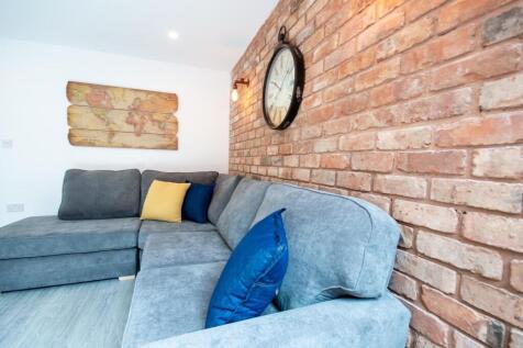 A modern living room featuring a comfortable gr...