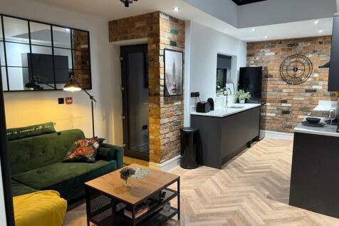 A stylish and modern living room featuring expo...