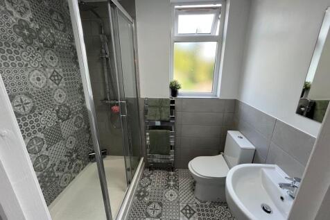 Bright and modern bathroom featuring patterned ...