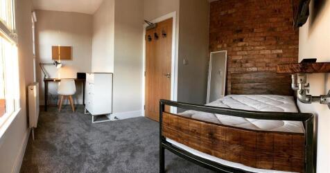 Bright and stylish bedroom featuring a cozy bed...