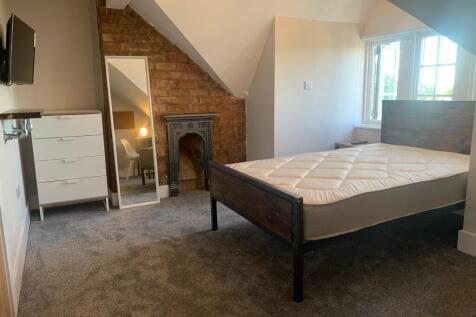 Spacious and well-lit bedroom featuring a sturd...