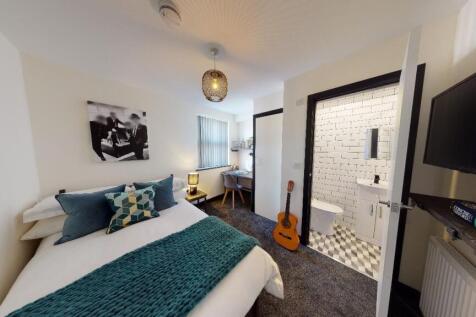 A cozy and well-maintained bedroom with a neatl...