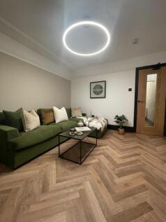 Modern and stylish living room featuring a comf...