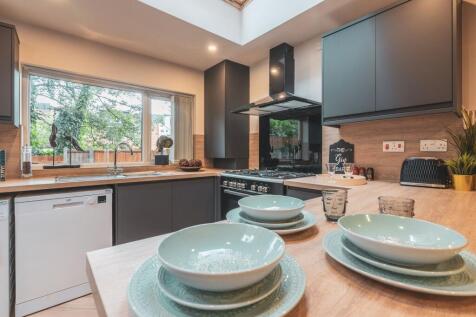 Modern and well-lit kitchen with large window, ...