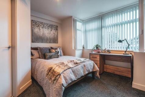 A bright, welcoming double bedroom featuring a ...