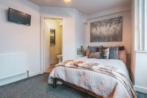 A spacious and well-presented bedroom featuring...
