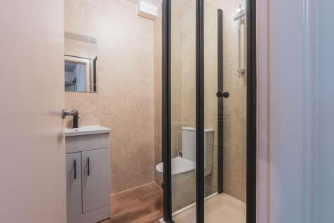 Modern bathroom with a compact shower enclosure...