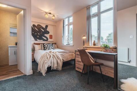 A modern and inviting bedroom featuring large w...