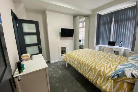 Bright, neatly furnished double bedroom with a ...