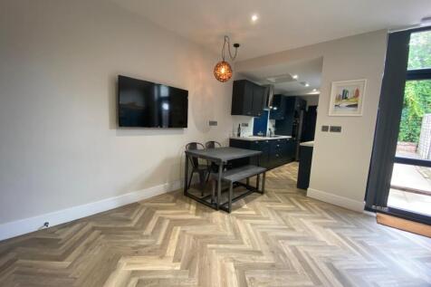 Bright open-plan living area with stylish herri...