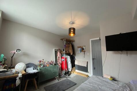 A cozy living room with various personal items,...