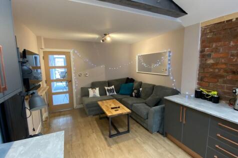 A cozy and welcoming living room featuring a co...