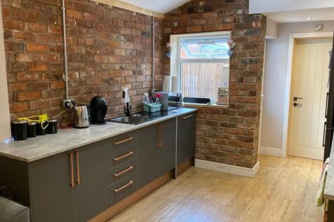 Modern kitchen featuring a sleek grey cabinetry...