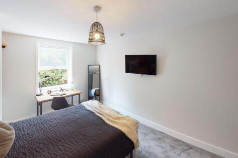 Bright and airy living room featuring a large w...