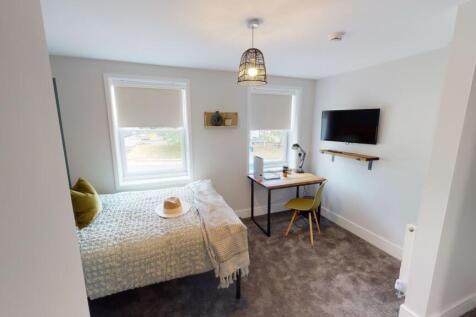 A bright and spacious living room with two larg...