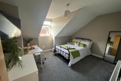 Bright, well-styled attic bedroom with a metal ...