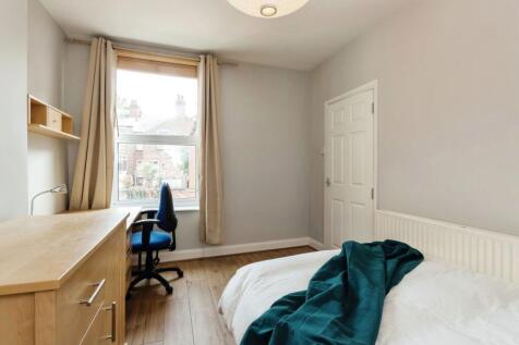 Bright and tidy bedroom featuring a comfortable...