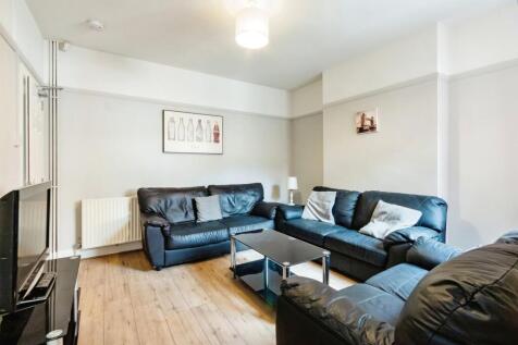 A spacious and contemporary living room featuri...