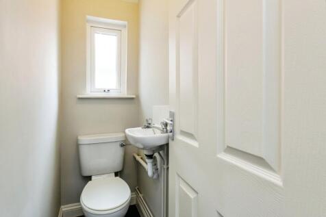 A compact, well-maintained bathroom featuring a...