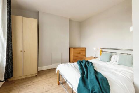 A clean, well-lit double bedroom featuring a co...