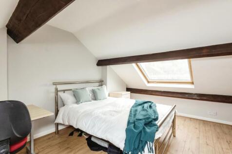 A bright, well-maintained bedroom featuring a c...