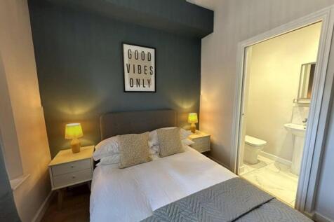 A cozy, well-maintained bedroom featuring a com...