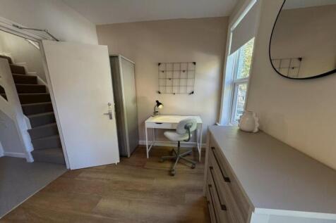 A bright and modern master bedroom featuring a ...