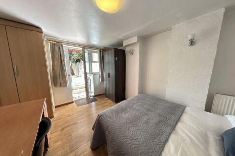 A cozy and well-maintained bedroom featuring a ...