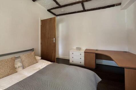 Cozy bedroom featuring a double bed with decora...