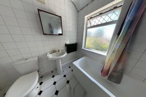 Functional bathroom featuring a toilet, sink, a...