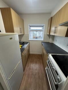 A tidy, functional kitchen with wooden cabinets...