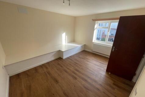 Bright and welcoming bedroom with a large windo...