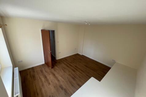 Bright and spacious living room with wooden flo...