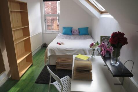 Bright and cozy single bedroom featuring a bed ...