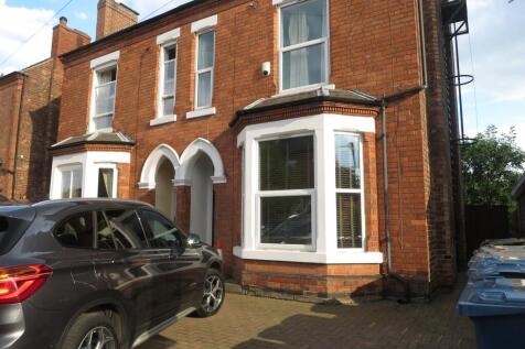 Exterior view of a charming brick house with wh...