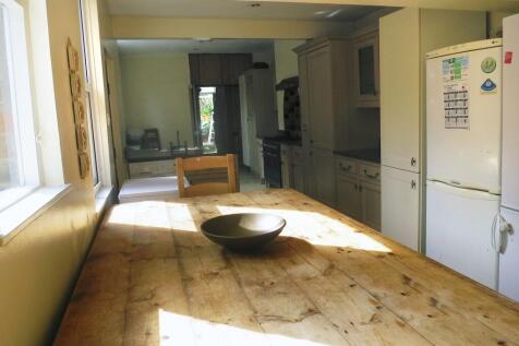 Bright and welcoming kitchen with ample natural...