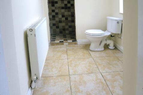 Clean and functional bathroom featuring a toile...
