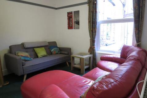 A bright, welcoming living room featuring a lar...