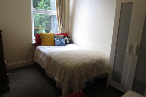 A cozy, well-maintained bedroom featuring a com...