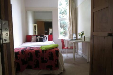 Bright and welcoming master bedroom featuring a...