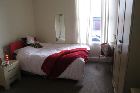 A bright, well-maintained bedroom featuring a l...