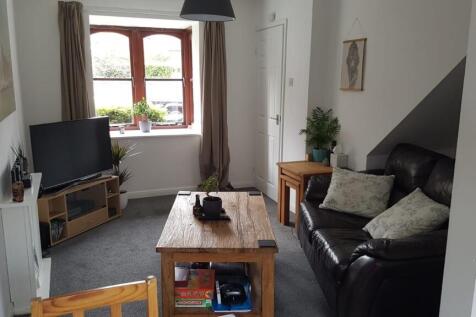 A bright and cozy living room featuring a large...