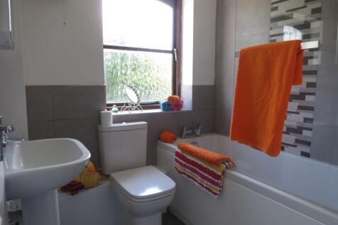 Bright and well-maintained bathroom featuring a...