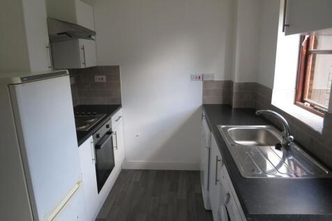 A bright and functional kitchen featuring white...
