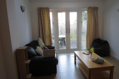 A welcoming living room filled with natural lig...