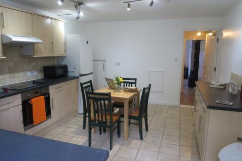 A bright and clean kitchen featuring a compact ...